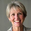 Portait of Sarah Miller, a woman in her early 50s with a warm, approachable smile.